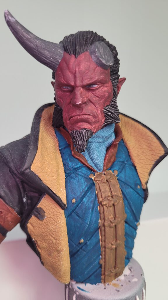 Bust of a Tiefling with a broken horn, in early stages of painting